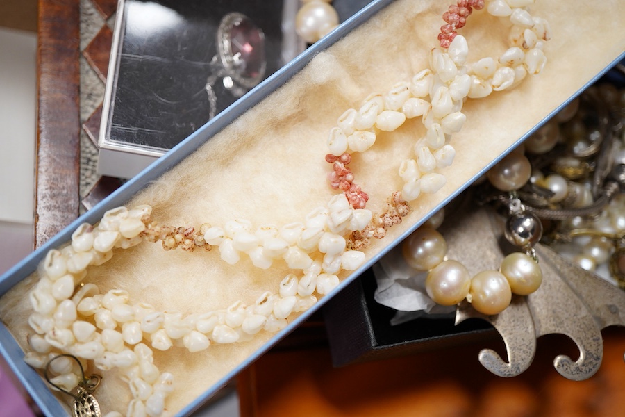 A cultured pearl necklace, composed of graduated cultured pearls of pale pink tint measuring approximately 11-12mm, to a spherical clasp stamped 14K; a black opal measuring approximatley 11 x 7mm, on a display cushion; a